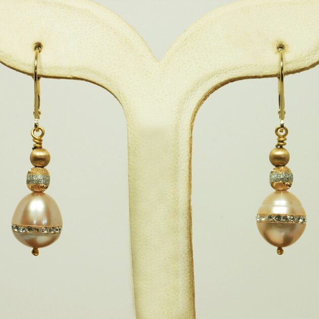 Freshwater pearl earrings studded with crystals.