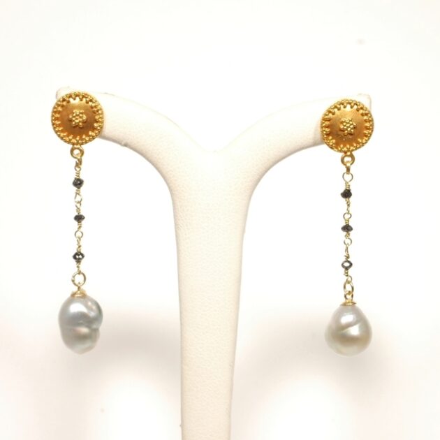Keshi pearl earrings studded with black diamonds.