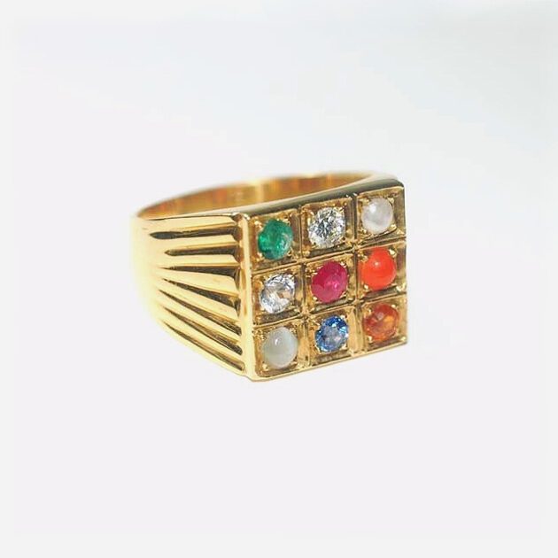 18K gold ring studded with 9 gemstones.