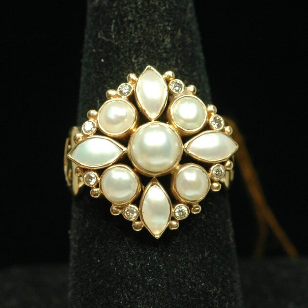 Pearl ring studded with diamonds.