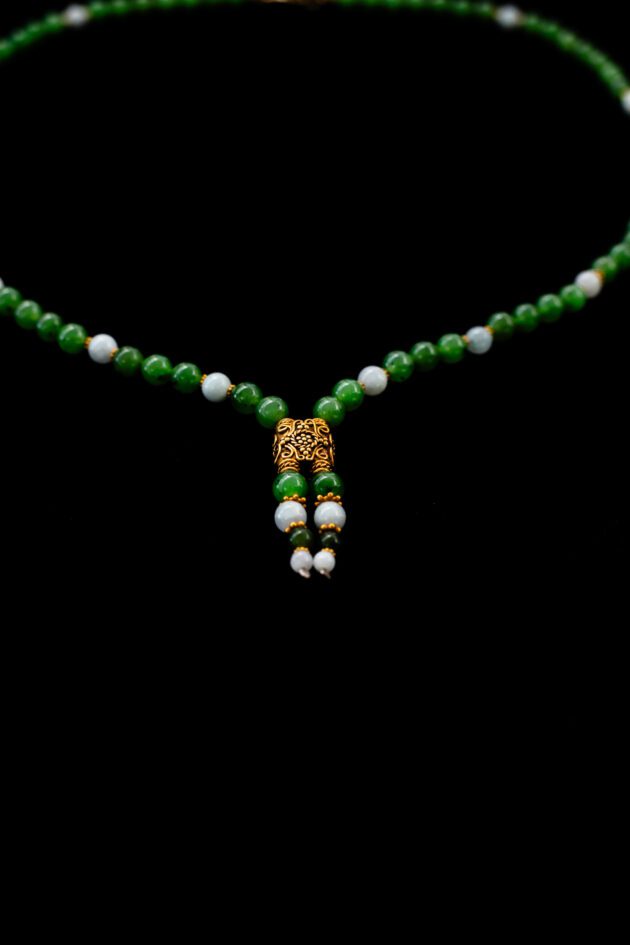 Designer jade bead necklace with 18K yellow gold details – modern statement piece.