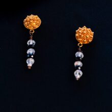 Luxury 22K gold granule earrings with moonstone and black diamond accents.