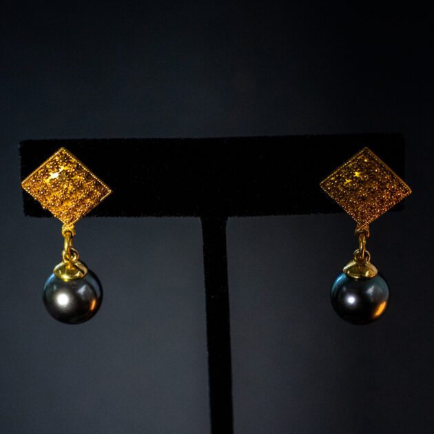 Luxury Tahitian black pearl drop earrings set in 22K yellow gold.