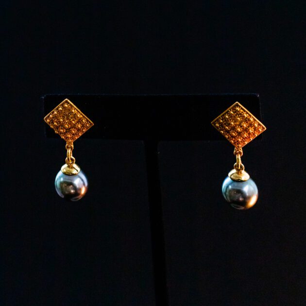 Designer dangle earrings featuring natural Tahitian black pearls and 22K gold.