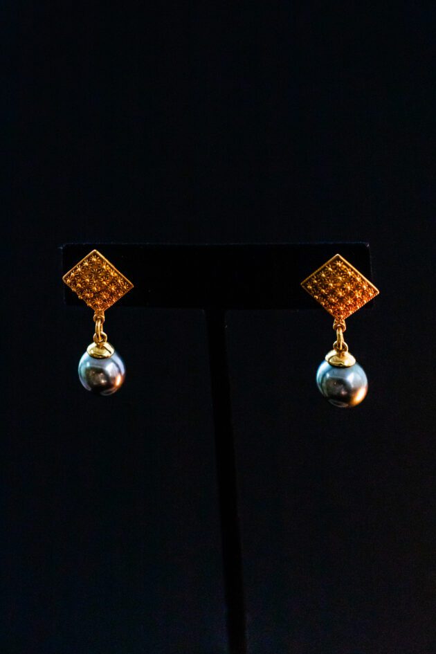 Designer dangle earrings featuring natural Tahitian black pearls and 22K gold. Designer dangle earrings featuring natural Tahitian black pearls and 22K gold.