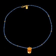 Traditional 22K gold Lakshmi oil lamp pendant on blue sapphire necklace