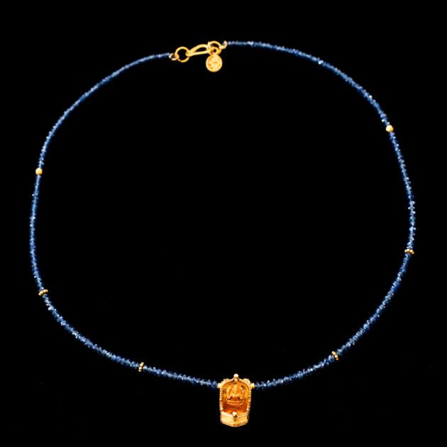 Traditional 22K gold Lakshmi oil lamp pendant on blue sapphire necklace