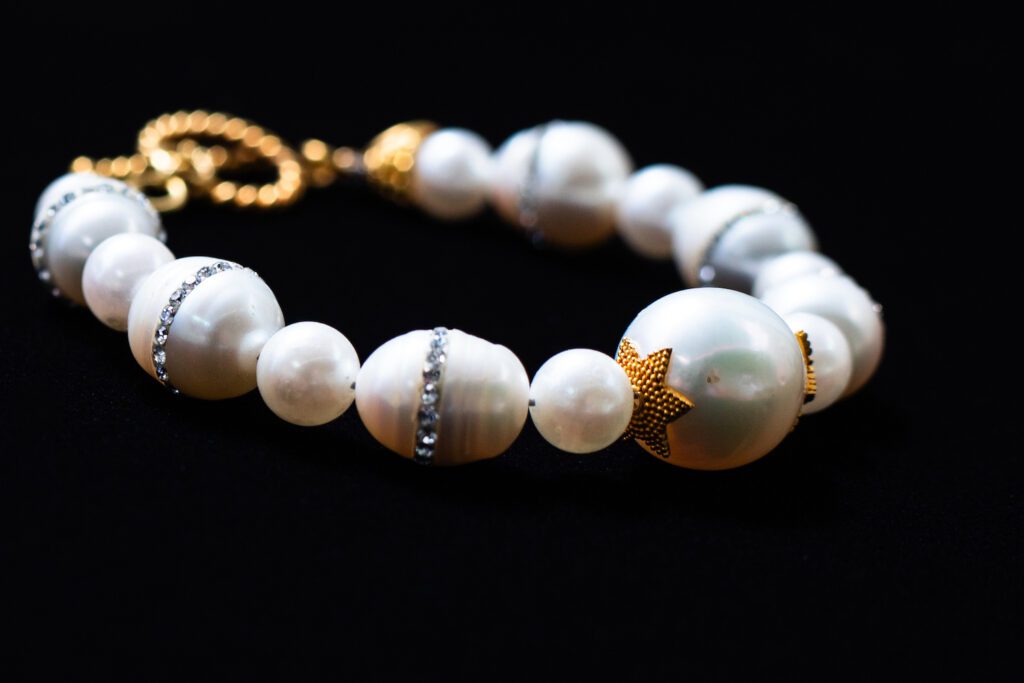 Luxury 18K gold bracelet adorned with lustrous cultured freshwater pearls.