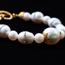 Luxury 18K gold bracelet adorned with lustrous cultured freshwater pearls.